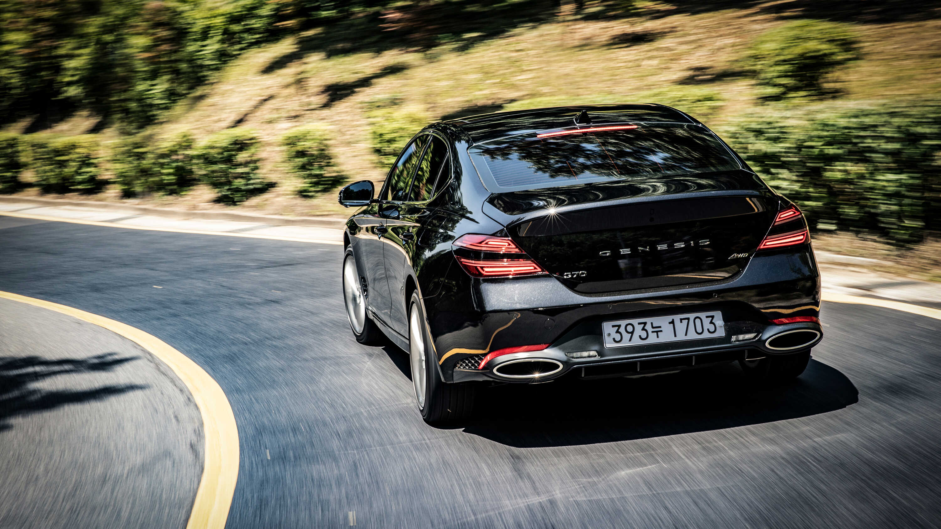 Rear view of the G70 driving on a hill