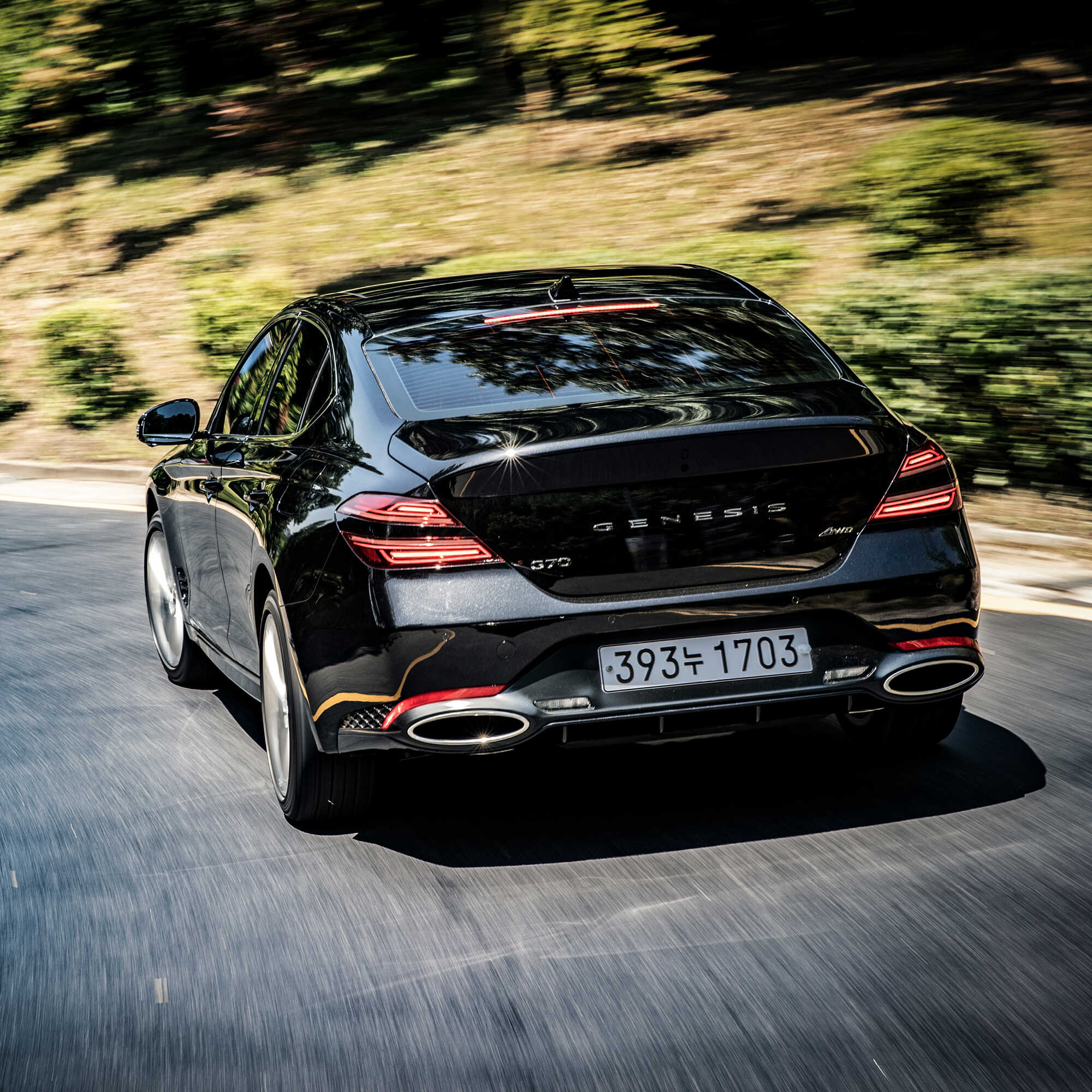 Rear view of the G70 driving on a hill