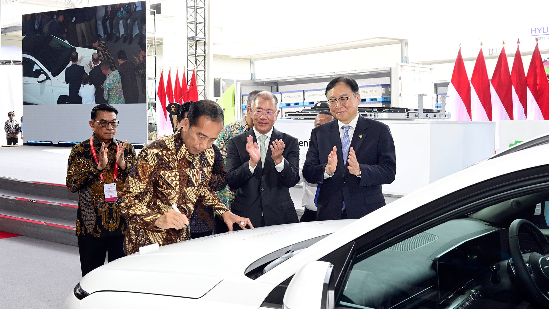 조코 위도도(Joko Widodo) 인도네시아 대통령이 HLI그린파워에서 생산한 배터리셀을 탑재한 디 올 뉴 코나 일렉트릭 1호차에 서명하고 있는 모습. 사진 오른쪽부터 정인교 통상교섭본부장, 정의선 현대차그룹 회장, 조코 위도도 인도네시아 대통령